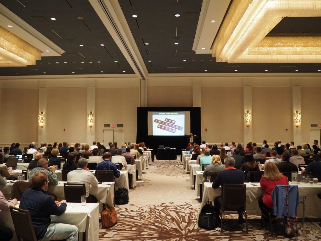 image of large group of people sitting and watching a presentation